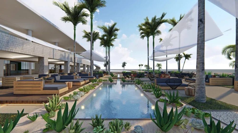 Moderna lounge all'aperto al Seaclub Ponta Sino, con sedute in legno intorno a una piscina rettangolare riflettente, circondata da palme e piante tropicali; le vele ombreggianti bianche e gli spazi aperti del Royal Horizon spiccano sotto il cielo blu.